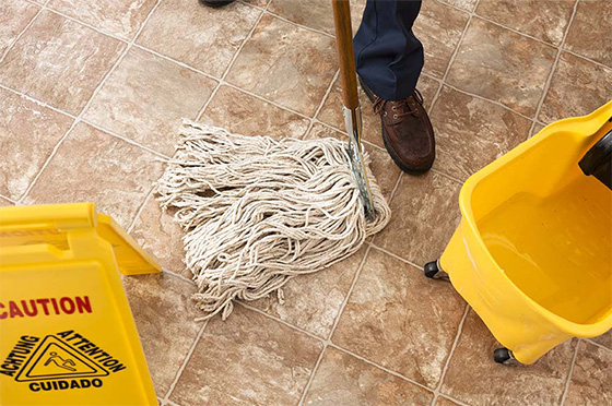 Mop being pushed on tile floor