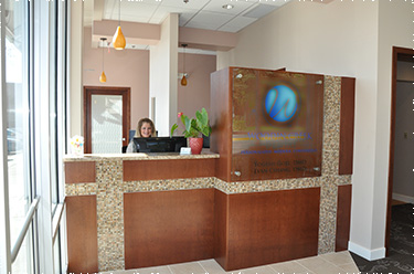 Clear, bright photo of front desk, showing the front desk staff