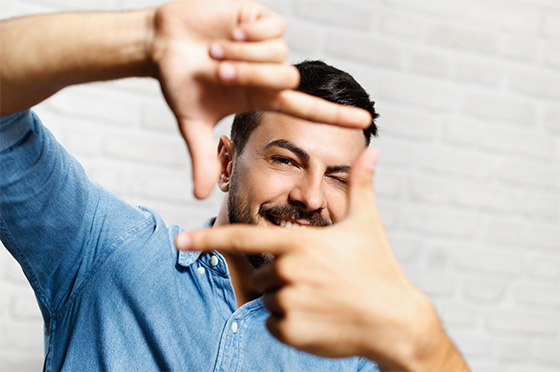 Man framing his subject with his hands