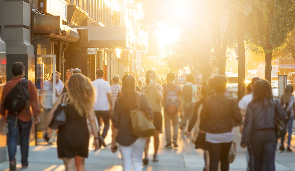 Out of focus image of people walking on a busy street